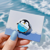 Customized cartoon penguin surfing sport badge